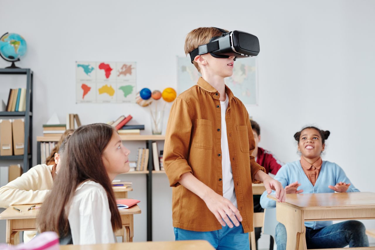 Home Children engaged with virtual reality headsets in a vibrant classroom setting, exploring immersive technology.